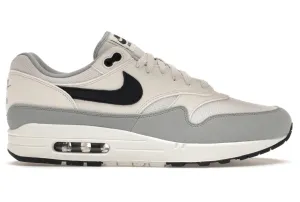 running on concrete shoes running in a tram station area shoes Nike Air Max 1 Platinum Tint Dark Obsidian