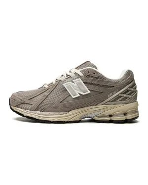 running in a marina area shoes New Balance 1906R Beige Cream